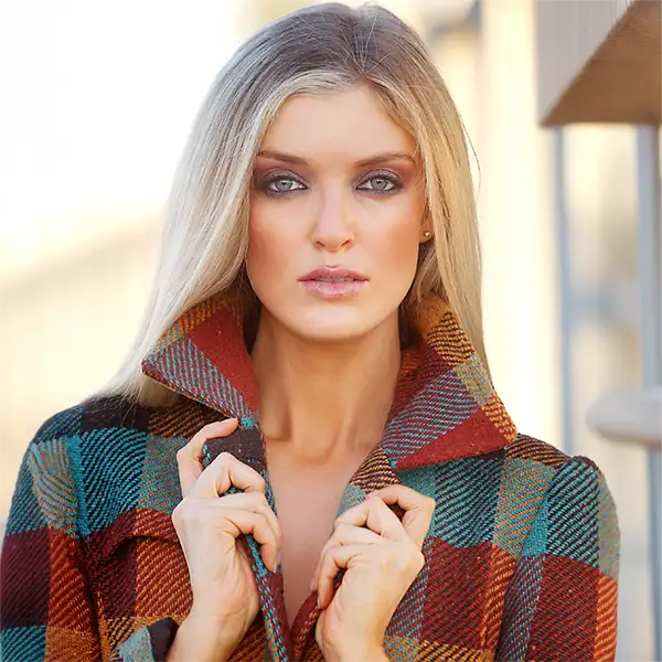 Blonde woman in a plaid coat, headshot portrait
